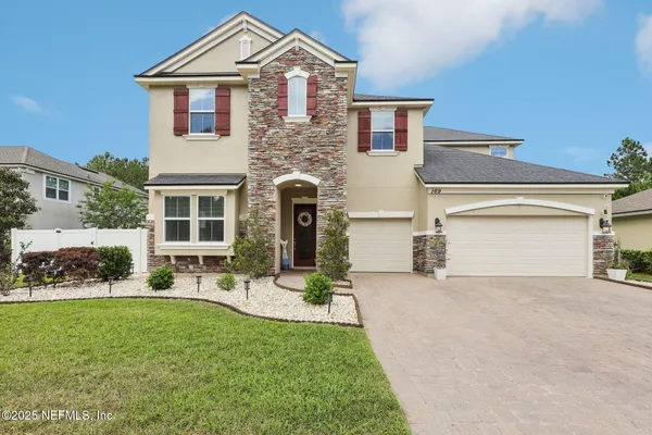 a front view of a house with a yard and garage