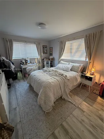 a bedroom with a bed and a couch
