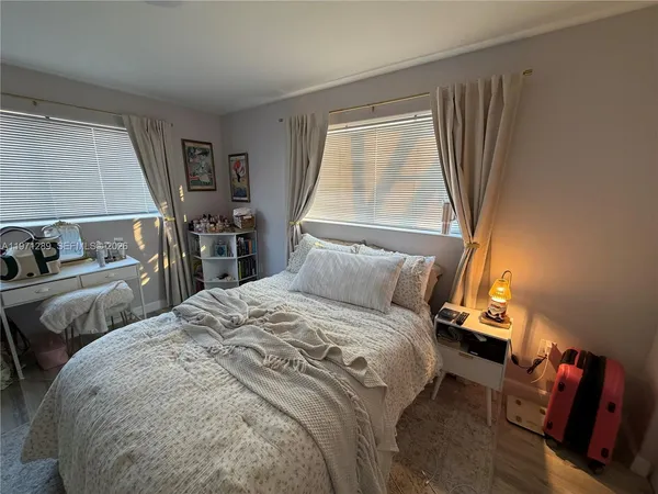 a bedroom with bed and a window