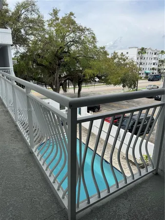 a view of a balcony with wooden floor and bench