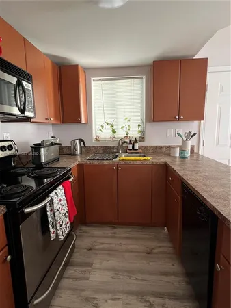 a kitchen with stainless steel appliances granite countertop a sink stove and cabinets