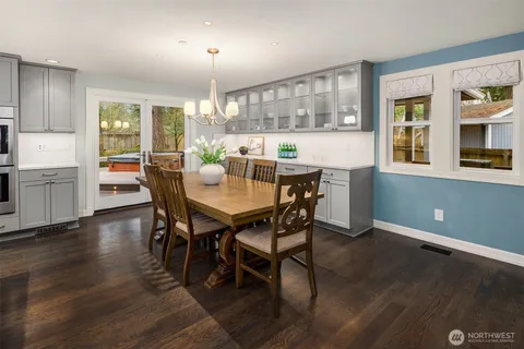 a view of a dining room with furniture and a kitchen