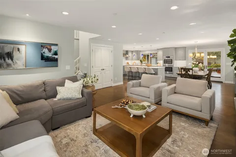 a living room with furniture and view of kitchen