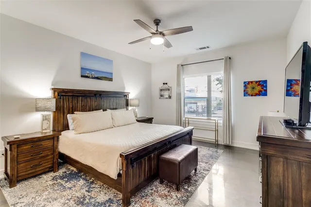 a bedroom with a large bed and a window