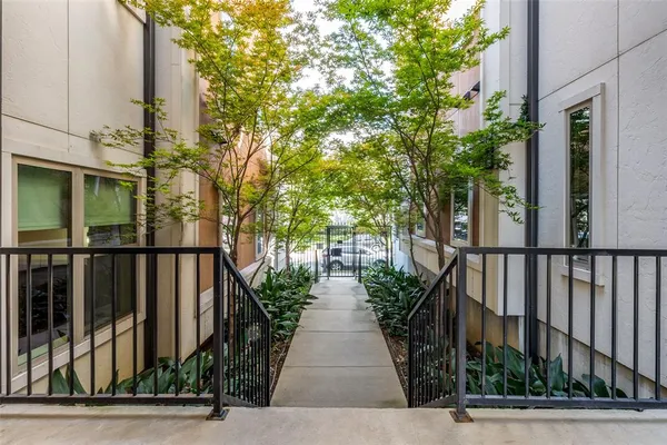 a view of a pathway both side of house with yard
