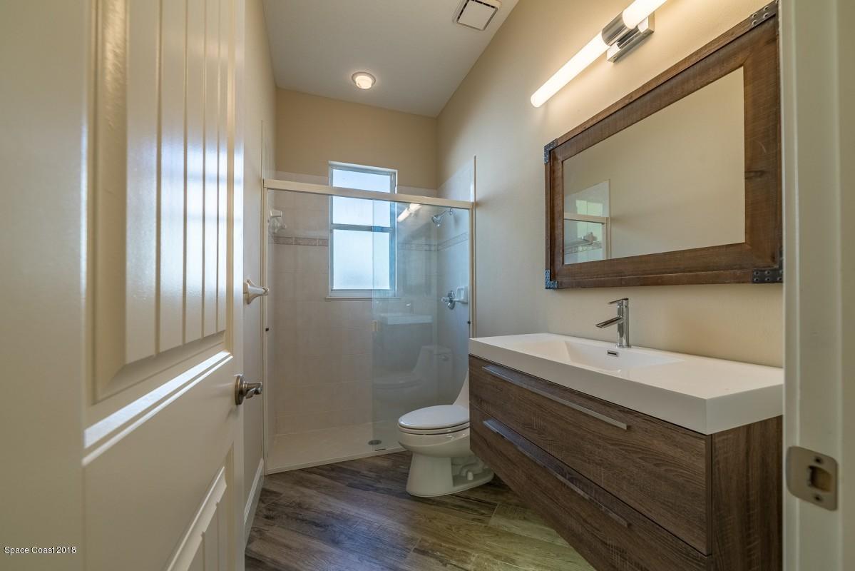 1725 Canterbury Drive Indialantic, FL 32903 - Photo 19 of 22 a bathroom with a toilet a sink and mirror