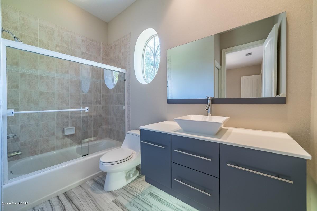 1725 Canterbury Drive Indialantic, FL 32903 - Photo 21 of 22 a bathroom with a sink a toilet and a mirror