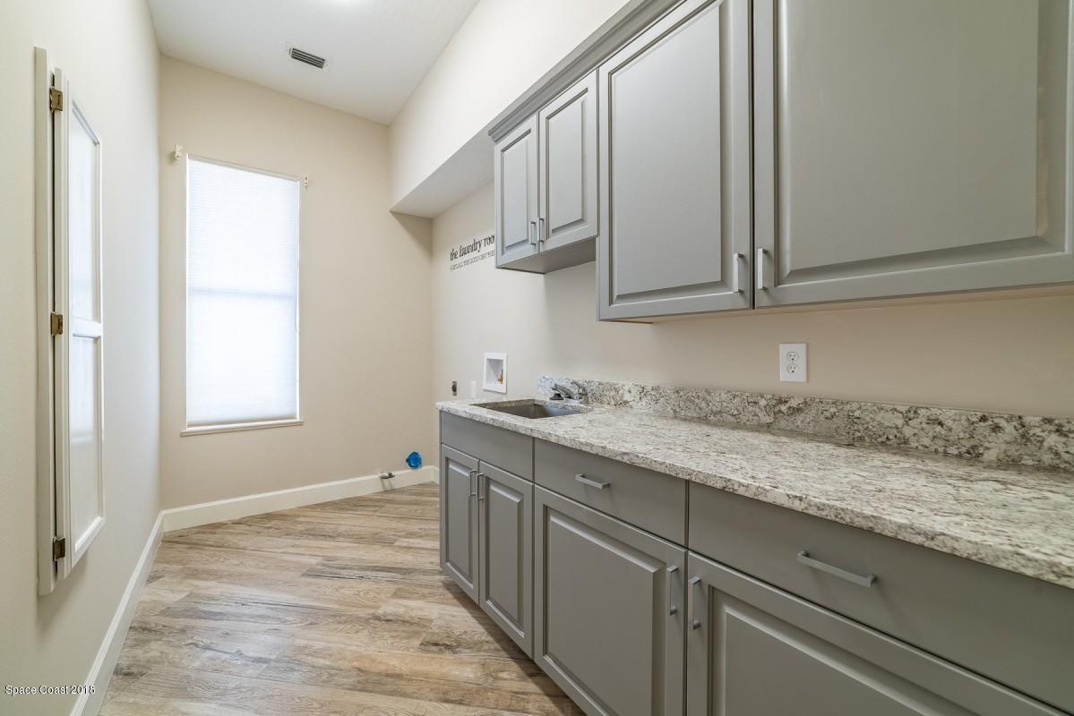 1725 Canterbury Drive Indialantic, FL 32903 - Photo 22 of 22 a kitchen with a sink and cabinets