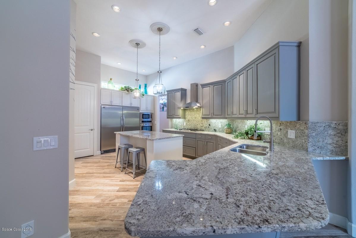 1725 Canterbury Drive Indialantic, FL 32903 - Photo 3 of 22 a large kitchen with granite countertop a large counter top appliances and cabinets