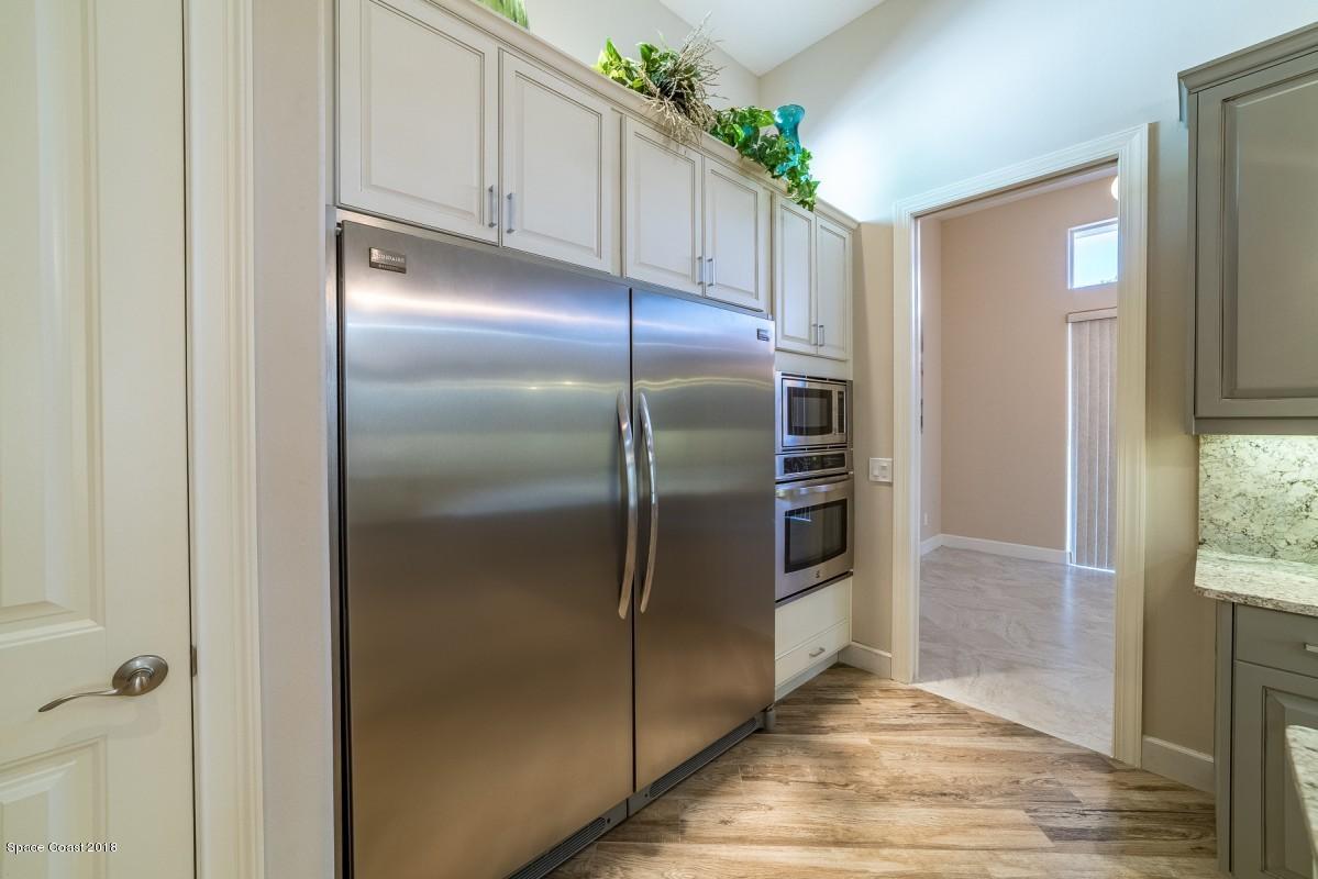1725 Canterbury Drive Indialantic, FL 32903 - Photo 4 of 22 a kitchen with metallic refrigerator freezer and a granite counter tops
