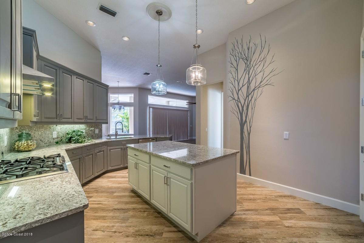 1725 Canterbury Drive Indialantic, FL 32903 - Photo 7 of 22 a large kitchen with stainless steel appliances granite countertop a sink a oven and a large window