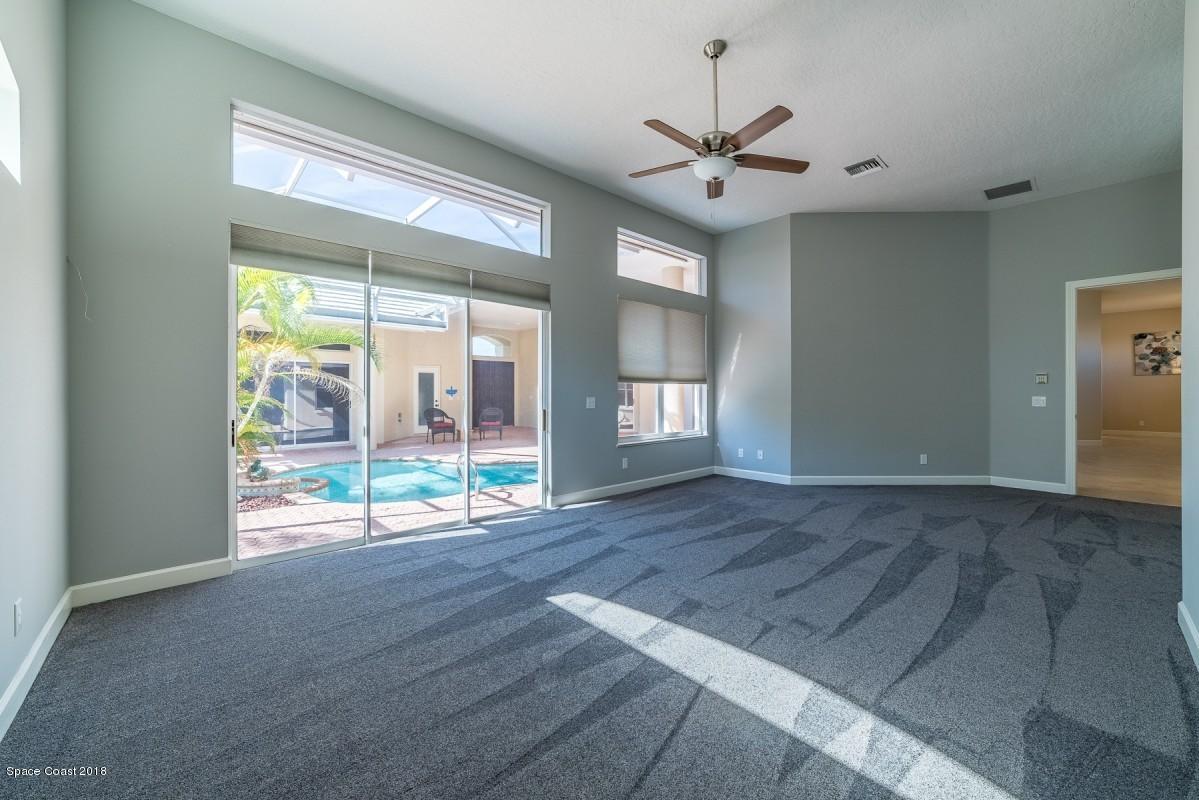 1725 Canterbury Drive Indialantic, FL 32903 - Photo 8 of 22 a view of an empty room with wooden floor and a window