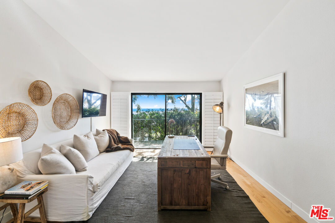 6801 Seawatch Lane Malibu, CA 90265 - Photo 14 of 34 a living room with furniture and a large window