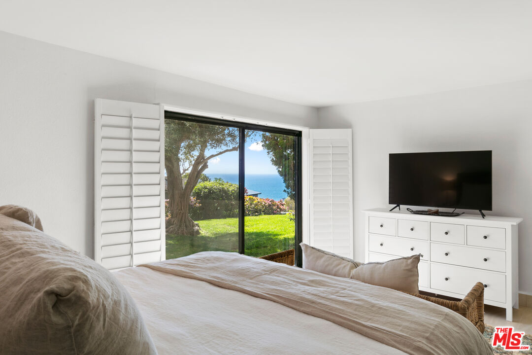 6801 Seawatch Lane Malibu, CA 90265 - Photo 19 of 34 a bedroom with a bed and a flat screen tv