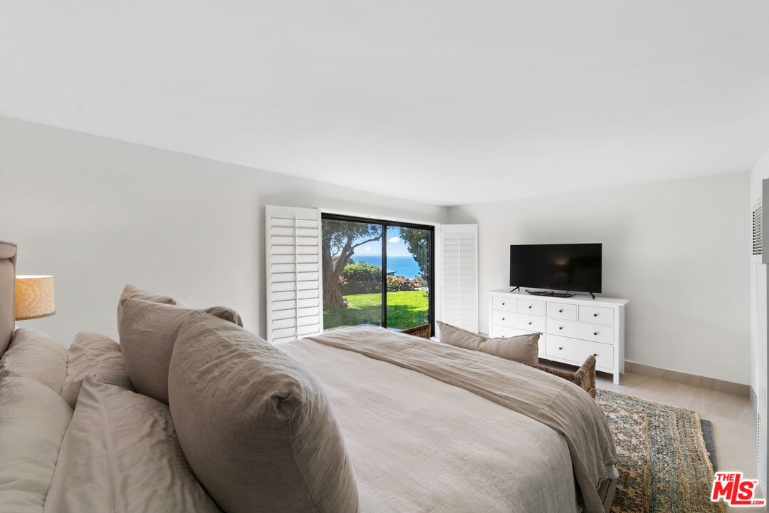 6801 Seawatch Lane Malibu, CA 90265 - Photo 20 of 34 a bedroom with a bed and a flat screen tv