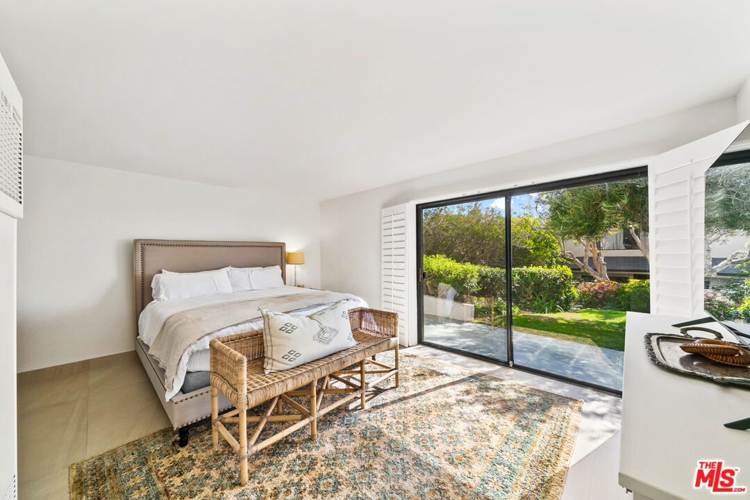 6801 Seawatch Lane Malibu, CA 90265 - Photo 21 of 34 a bedroom with a bed and a large window
