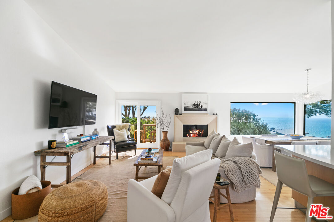 6801 Seawatch Lane Malibu, CA 90265 - Photo 3 of 34 a living room with furniture and a flat screen tv