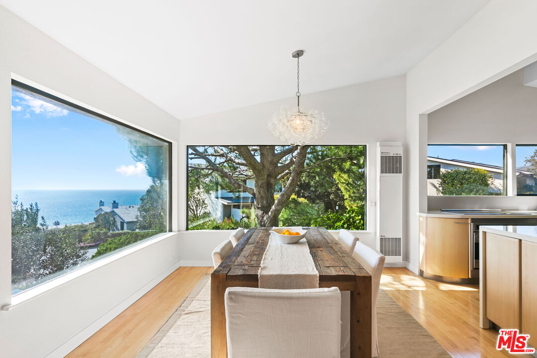 6801 Seawatch Lane Malibu, CA 90265 - Photo 10 of 34 a view of a city from a dining room with large windows