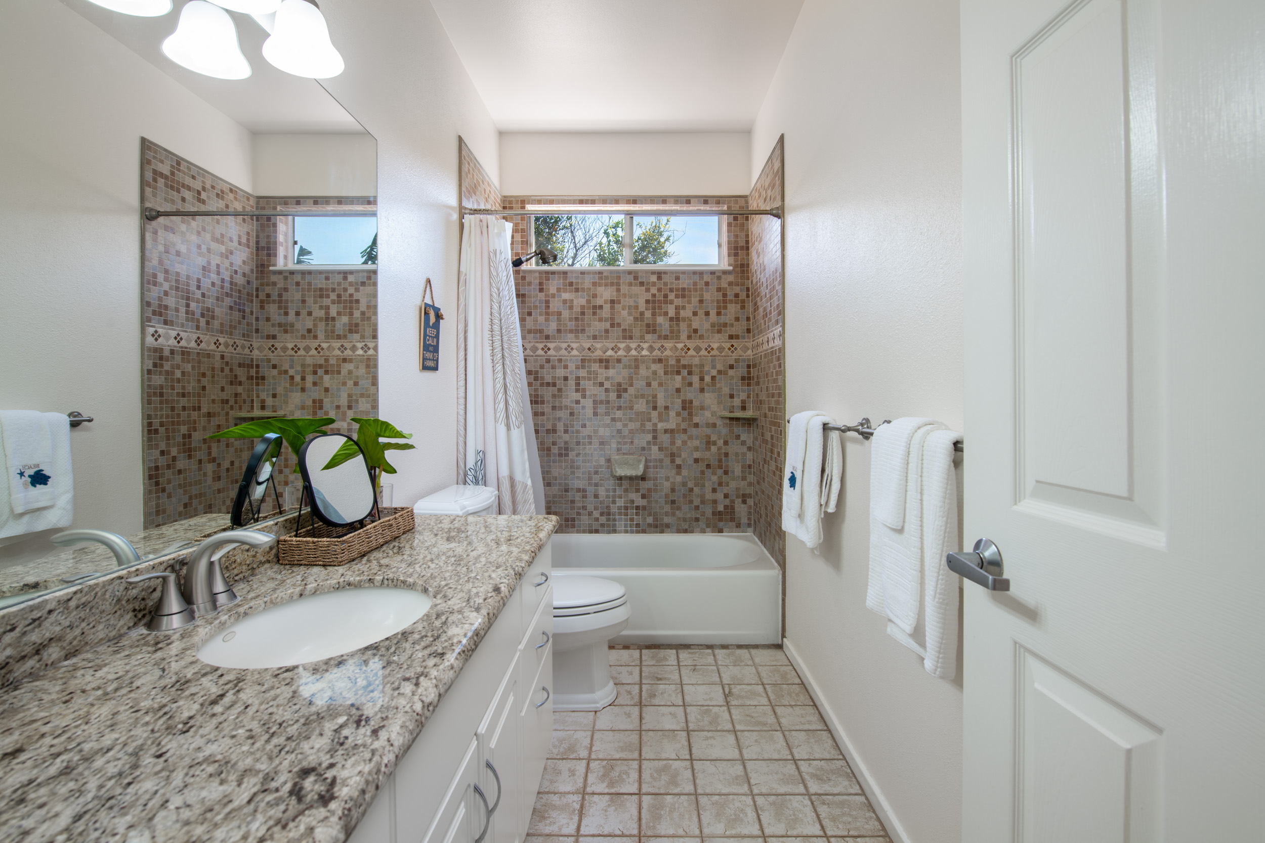 68-3559 Awamoa Place Waikoloa, HI 96738 - Photo 14 of 28 a bathroom with a granite countertop sink a toilet and shower