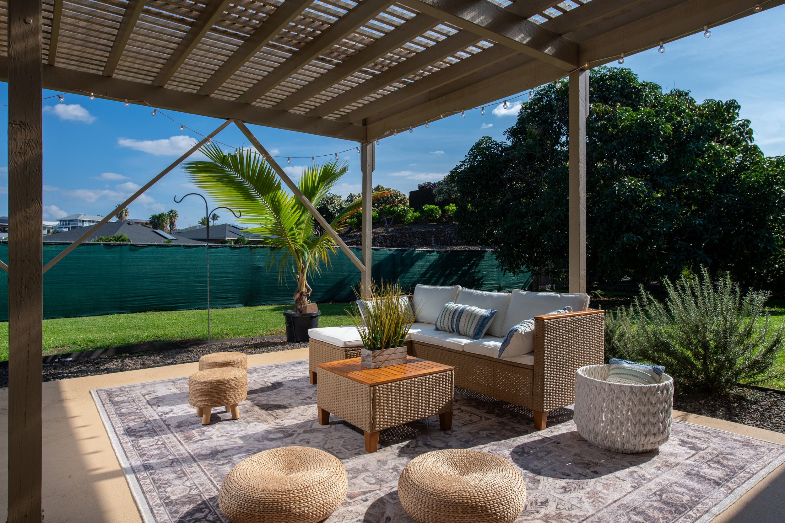 68-3559 Awamoa Place Waikoloa, HI 96738 - Photo 17 of 28 a view of a patio with couches table and chairs potted plants and palm tree