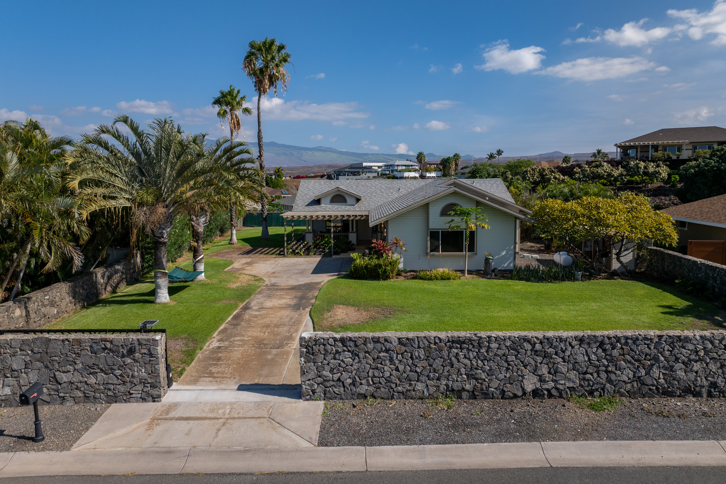68-3559 Awamoa Place Waikoloa, HI 96738 - Photo 22 of 28 a front view of a house with a yard and plants