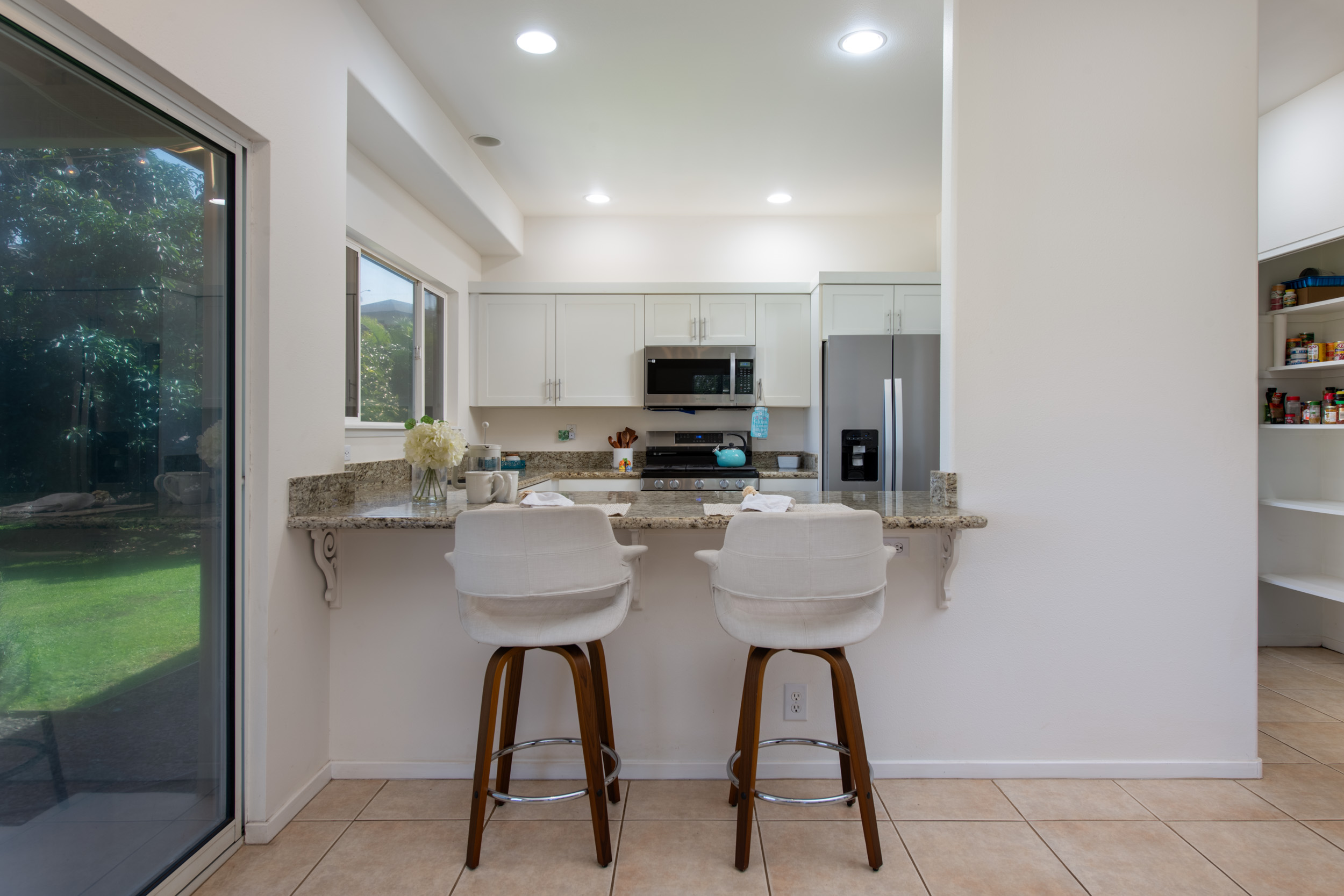 68-3559 Awamoa Place Waikoloa, HI 96738 - Photo 7 of 28 a kitchen with stainless steel appliances a refrigerator and a stove top oven