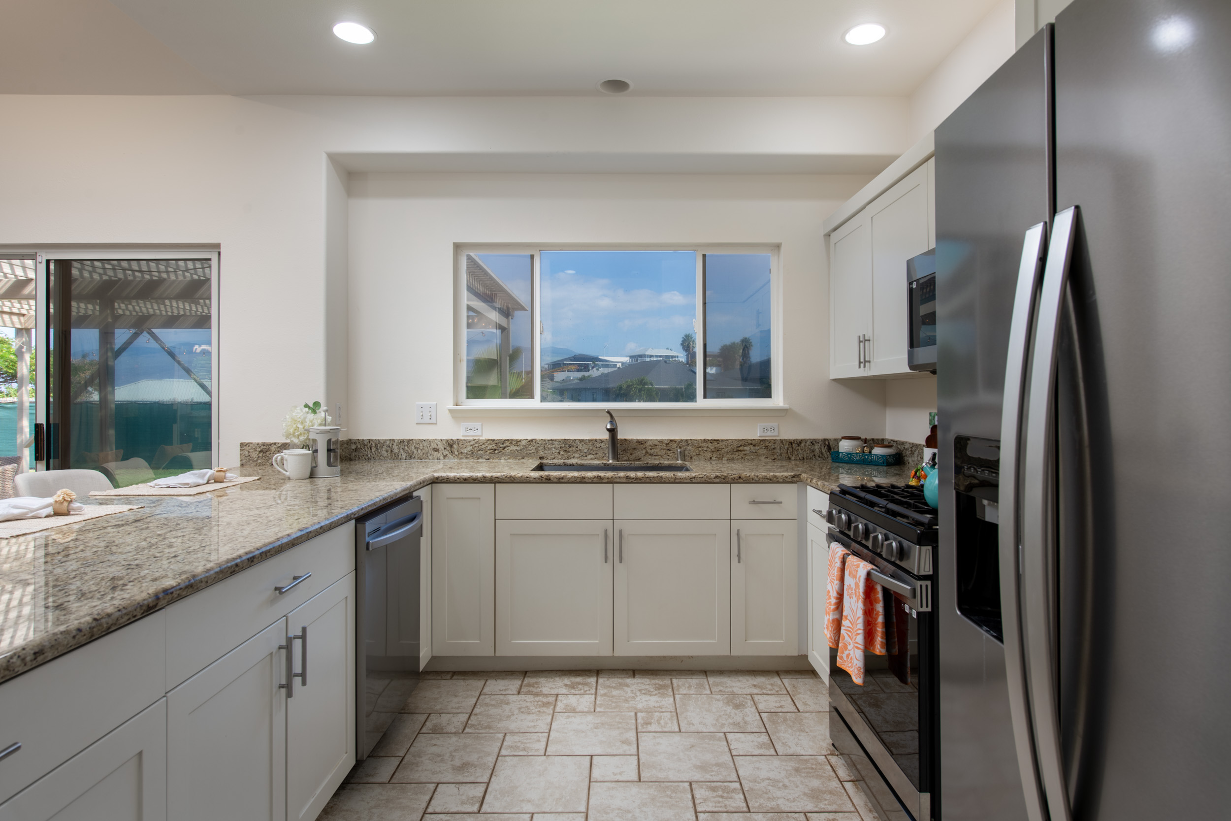 68-3559 Awamoa Place Waikoloa, HI 96738 - Photo 8 of 28 a kitchen with a sink stove and refrigerator