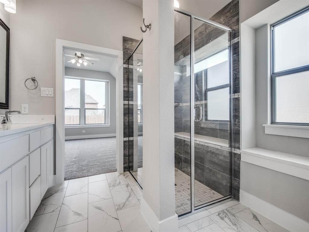139 Lakeview Circle Pilot Point, TX 76258 - Photo 9 of 19 Full bath featuring a ceiling fan, marble finish floor, and a stall shower