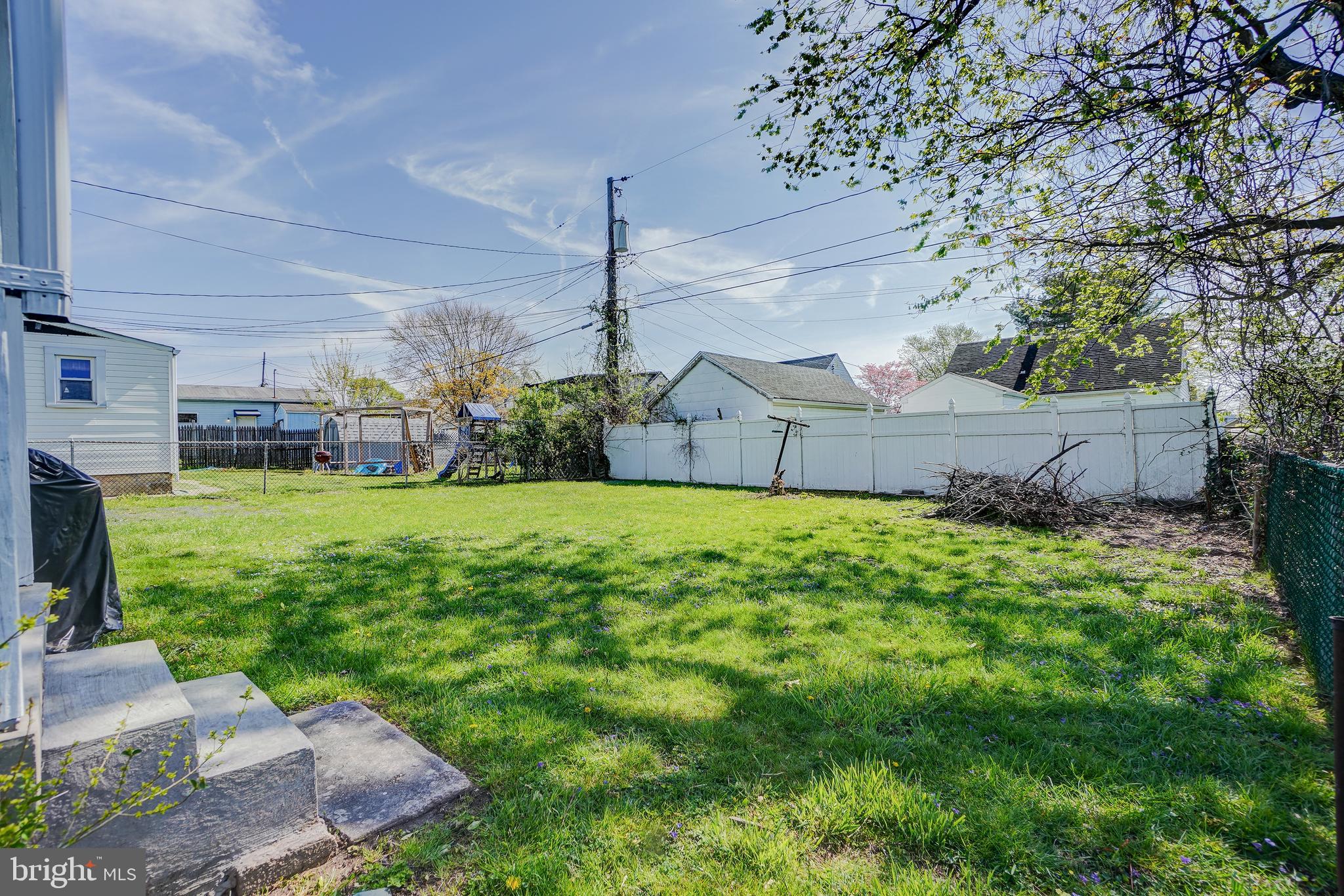 8 Avenal Road Essex, MD 21221 - Photo 17 of 17 a view of a house with a big yard potted plants and large tree