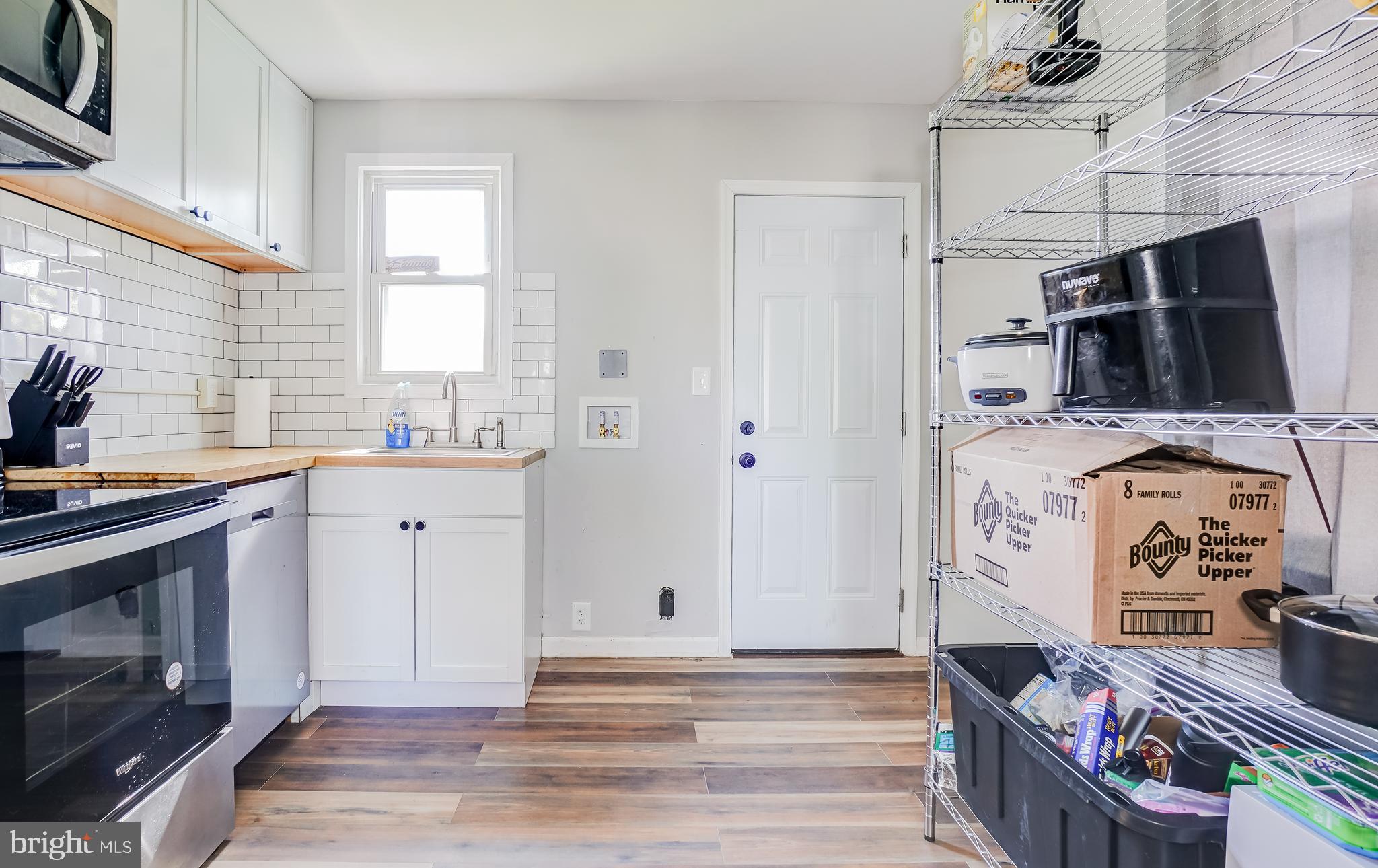 8 Avenal Road Essex, MD 21221 - Photo 7 of 17 a view of a kitchen with utility room and windows