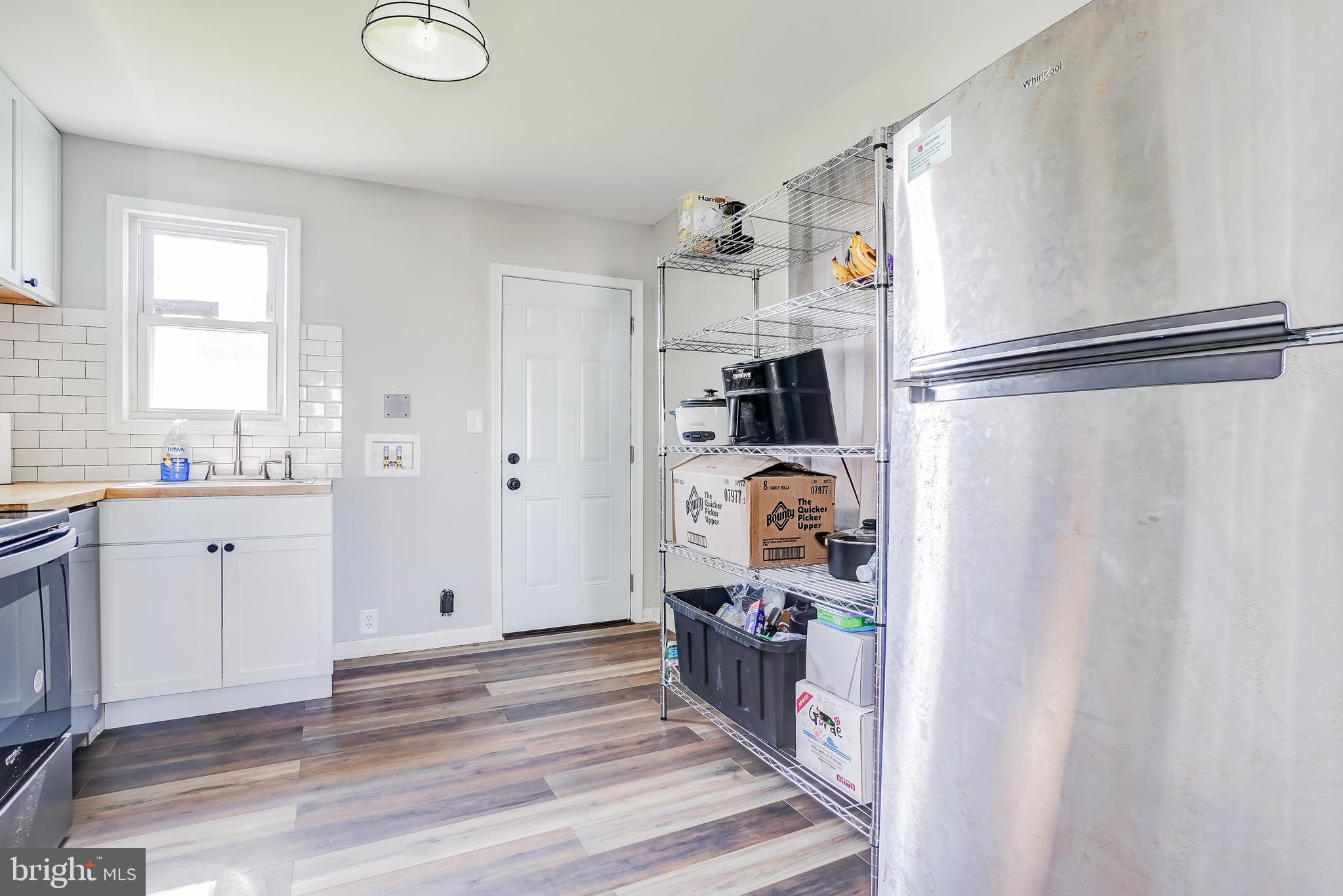 8 Avenal Road Essex, MD 21221 - Photo 8 of 17 a kitchen with refrigerator and window