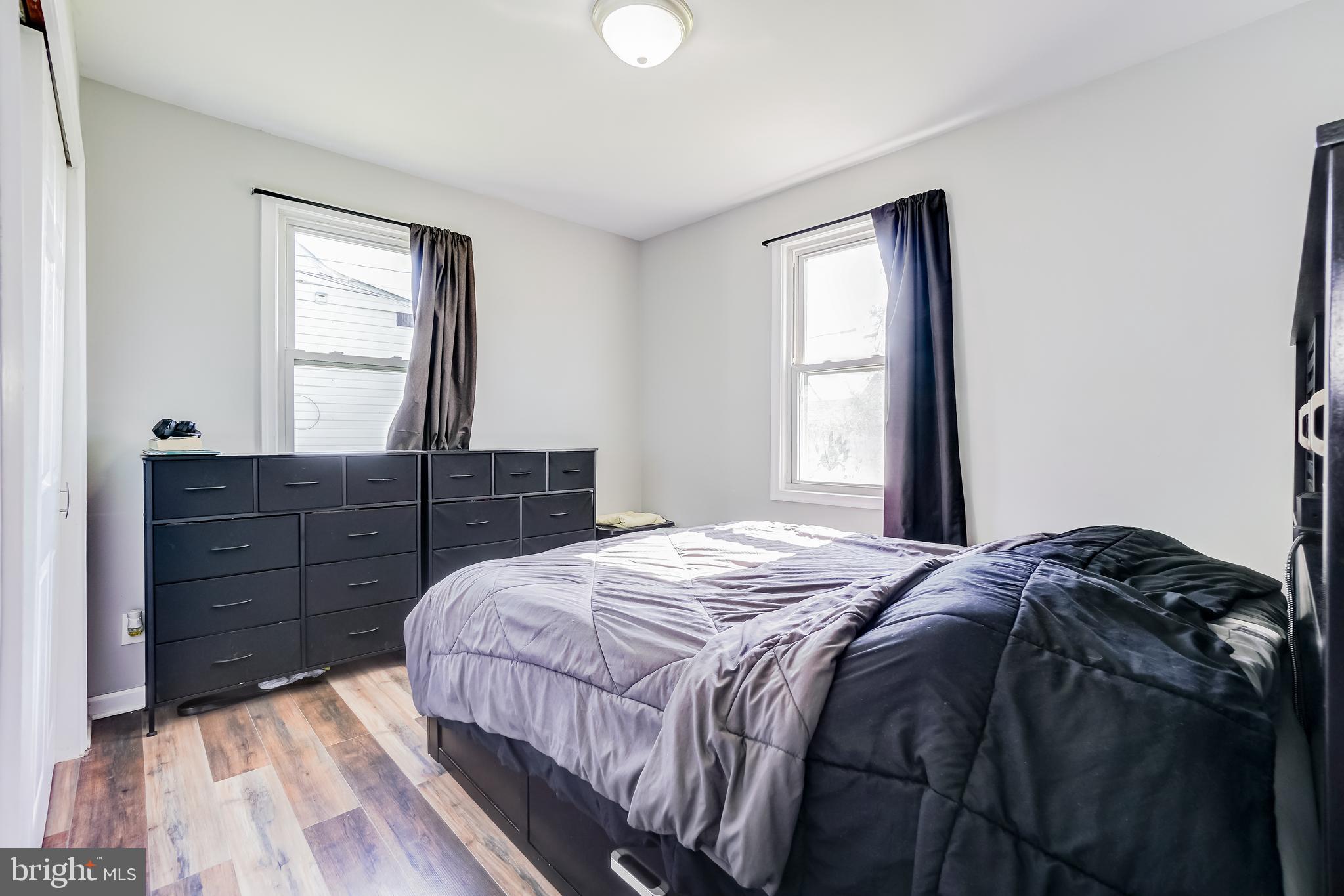 8 Avenal Road Essex, MD 21221 - Photo 10 of 17 a bedroom with a bed and wooden floor