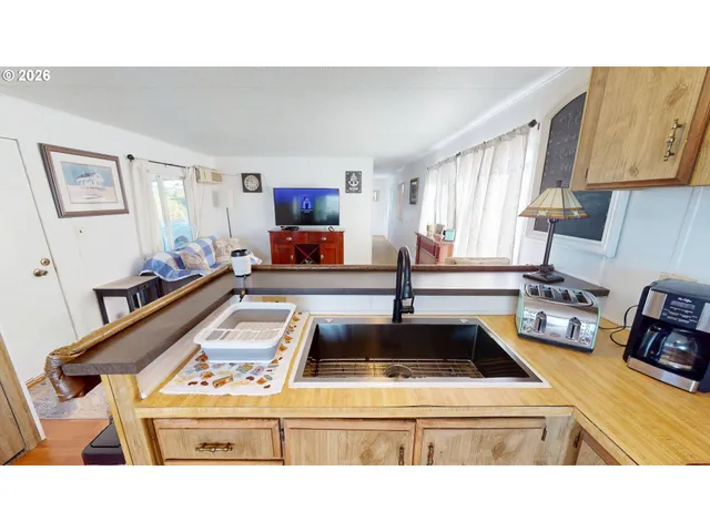 a kitchen with kitchen island granite countertop a sink stove and cabinets