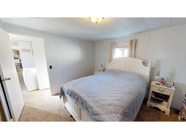 a living room with a bed and a window