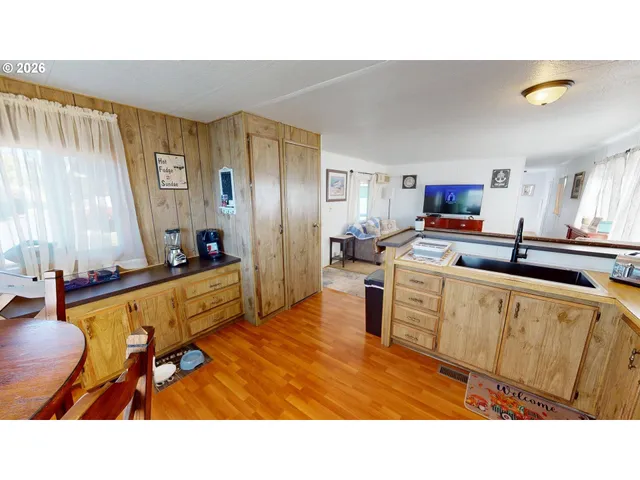 a kitchen with sink refrigerator and microwave