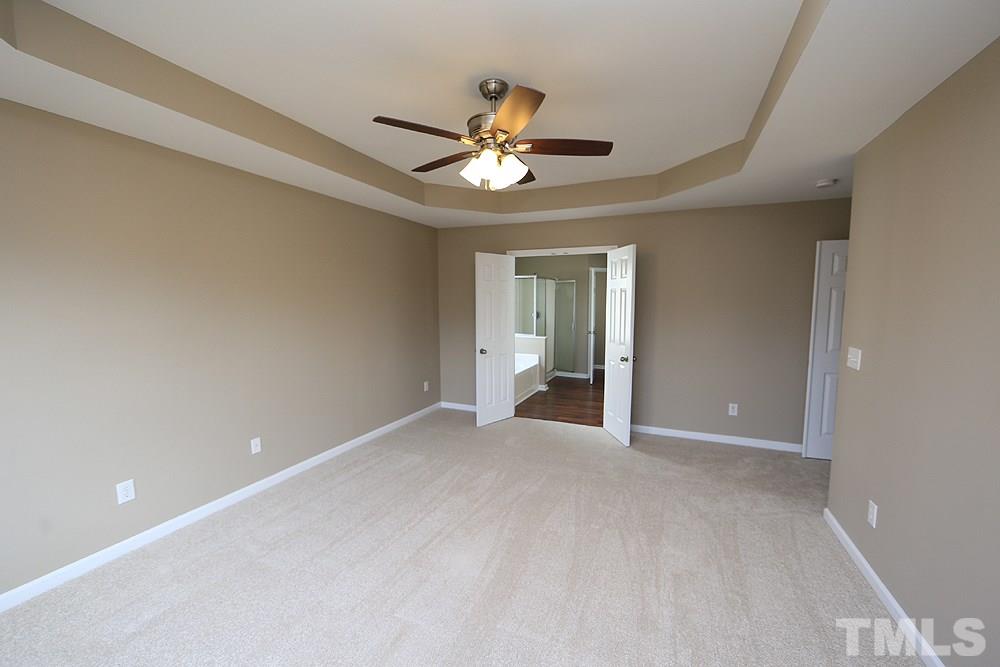 7729 San Gabriel Street Raleigh, NC 27613 - Photo 14 of 24 a view of a livingroom with a ceiling fan and window