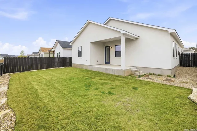 a view of a house with a yard and garage