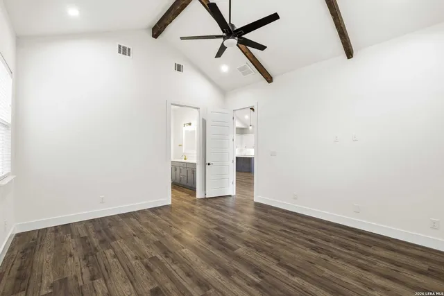 a view of empty room with wooden floor