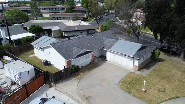 an aerial view of a house with a yard