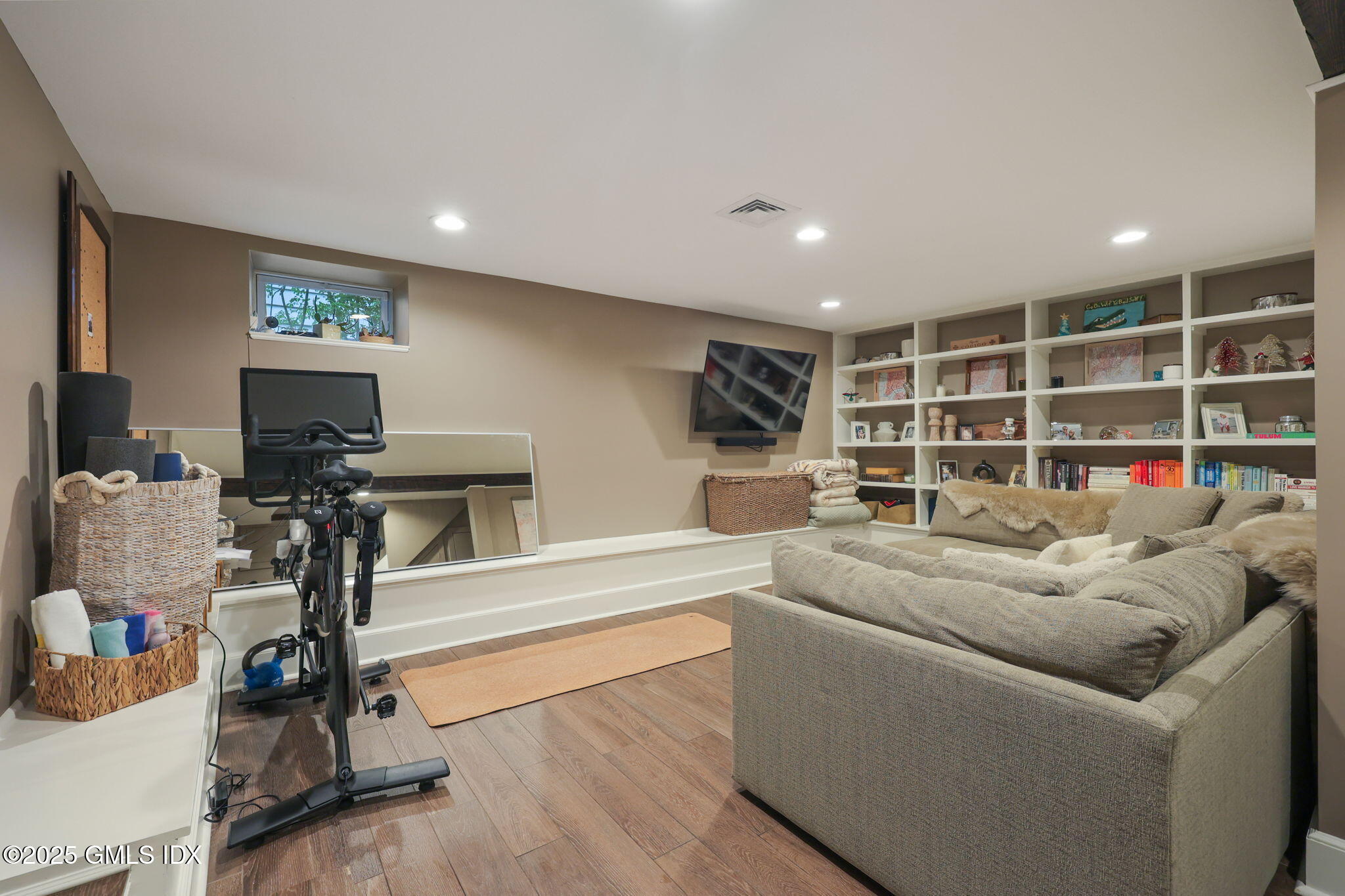 9 Cottage Place Greenwich, CT 06830 - Photo 17 of 21 a living room with furniture and a flat screen tv with kitchen view