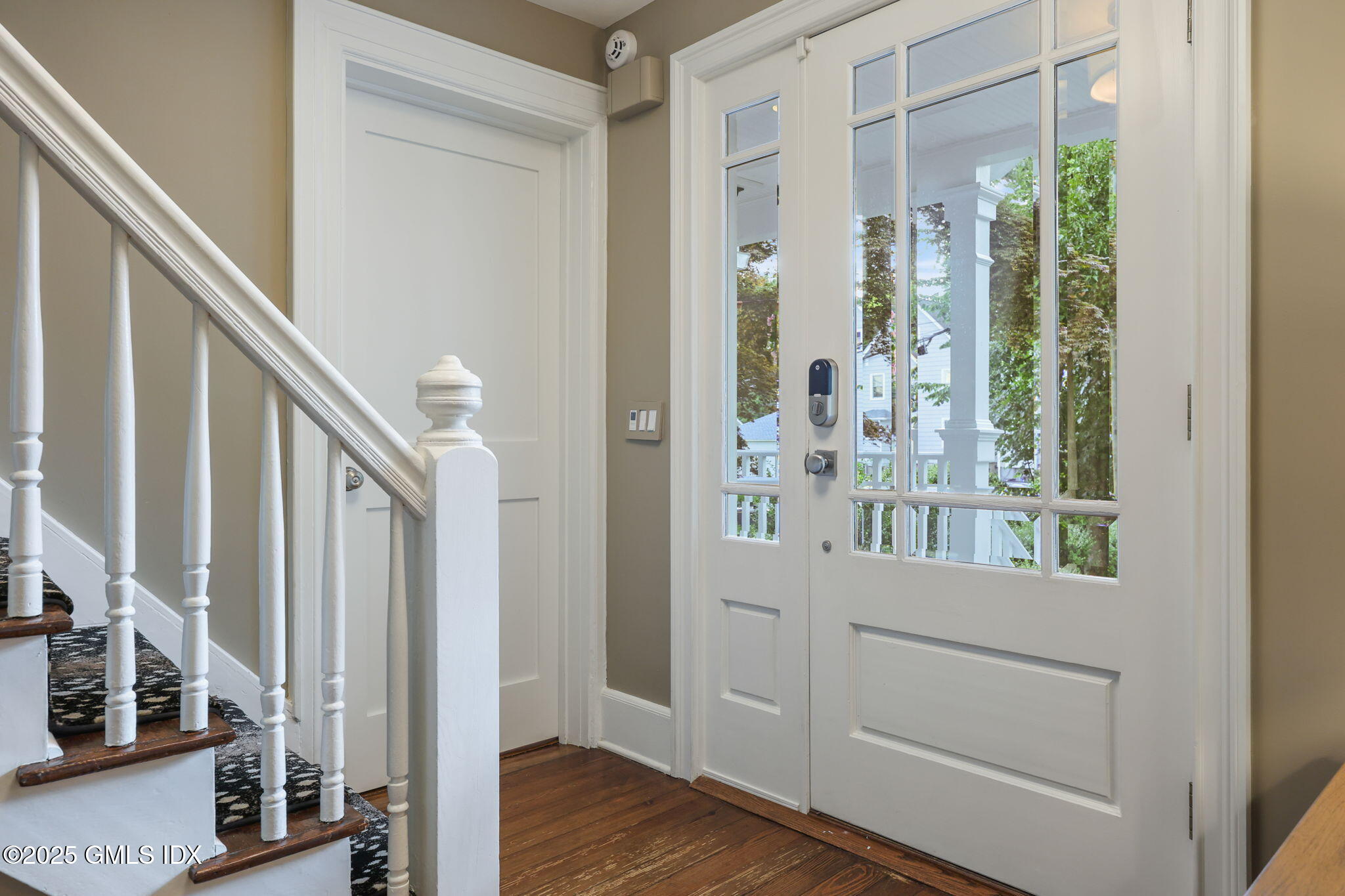 9 Cottage Place Greenwich, CT 06830 - Photo 4 of 21 a view of a hallway with wooden floor and staircase