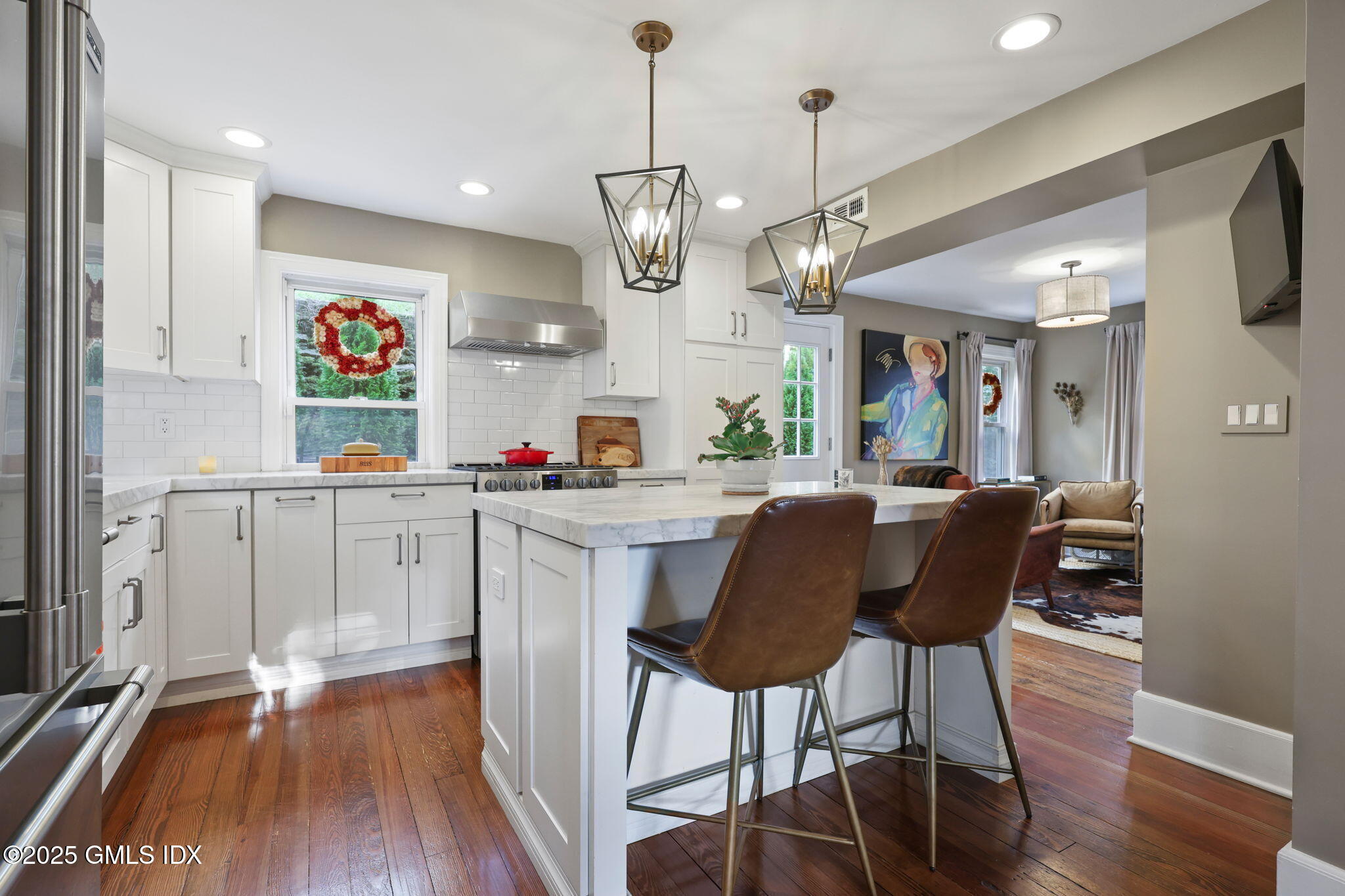 9 Cottage Place Greenwich, CT 06830 - Photo 7 of 21 a kitchen with stainless steel appliances kitchen island granite countertop a table chairs and a wooden floor