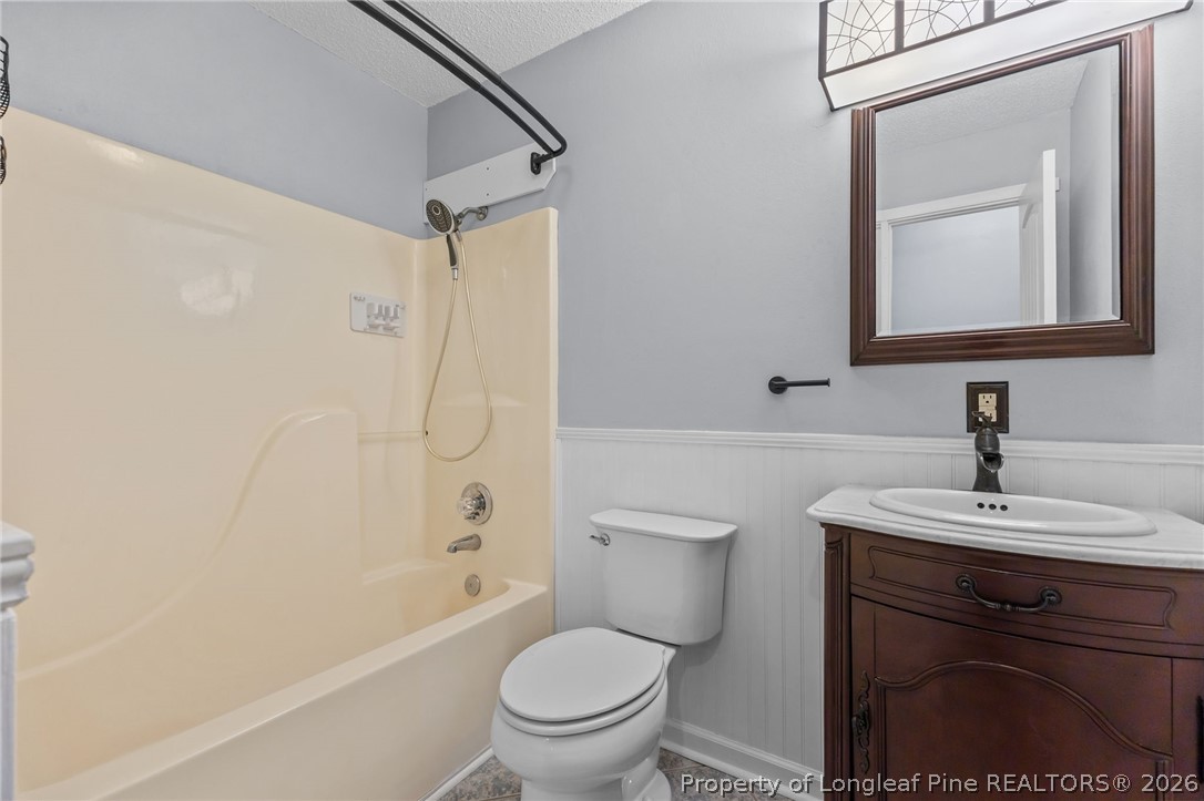 237 Lemuel Black Road Bunnlevel, NC 28323 - Photo 4 of 37 a bathroom with a toilet sink vanity shower and mirror