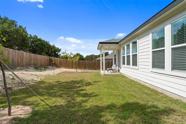a swimming pool with outdoor seating and yard