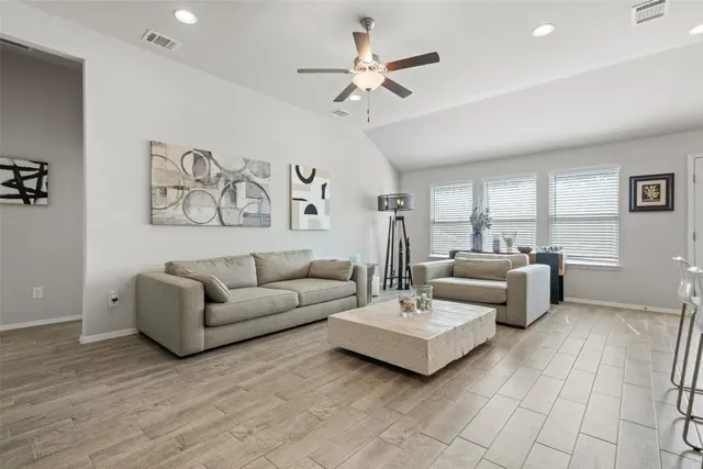 a living room with furniture and a large window