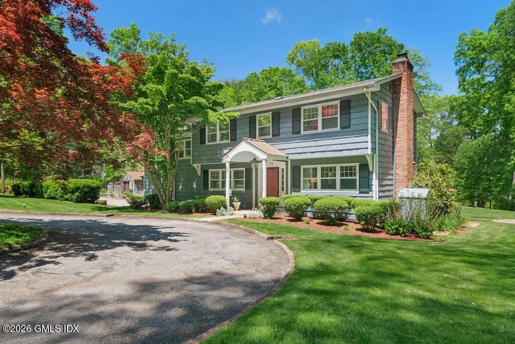 73 Thunder Mountain Road Greenwich, CT 06831 - Photo 2 of 19 a front view of a house with a yard