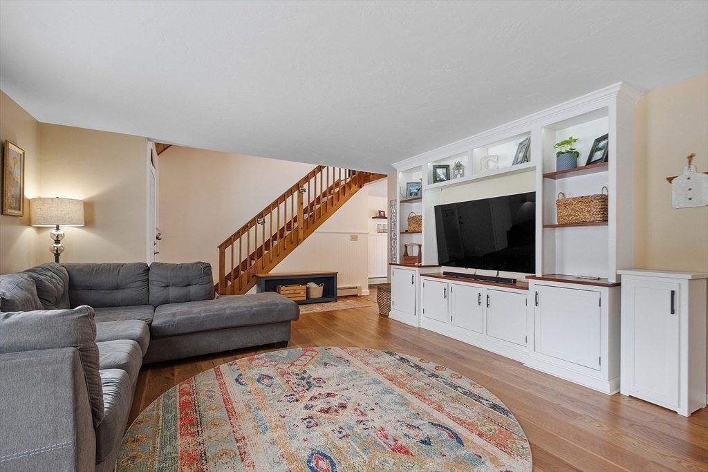 64 Peabody Road, Unit A Shirley, MA 01464 - Photo 3 of 29 a living room with furniture and a flat screen tv