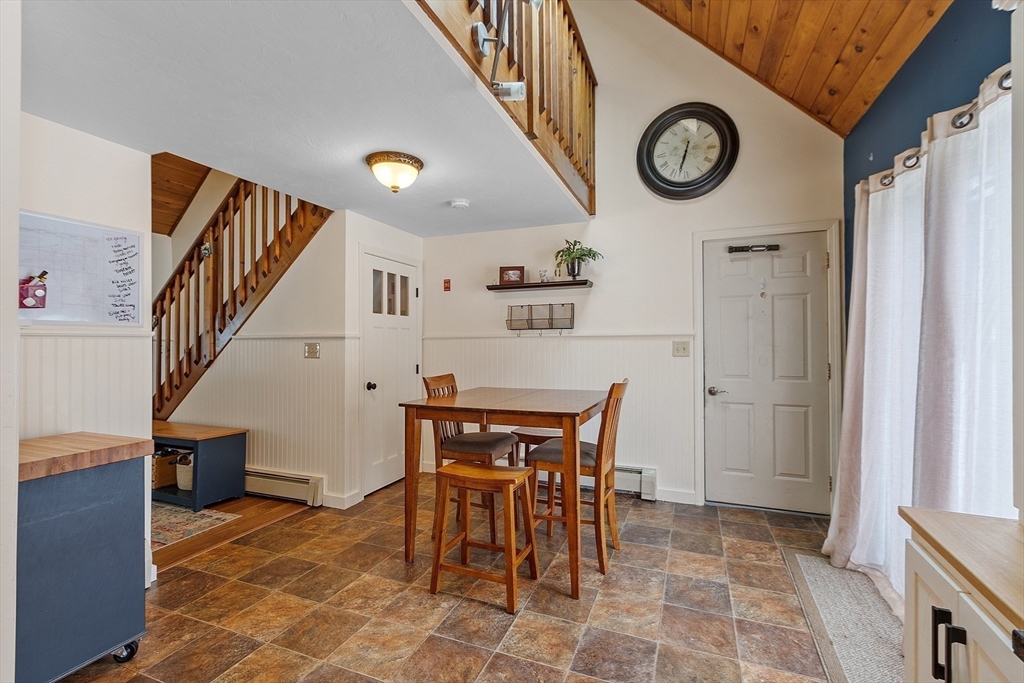 64 Peabody Road, Unit A Shirley, MA 01464 - Photo 9 of 29 a view of a dining room and kitchen with furniture and a clock