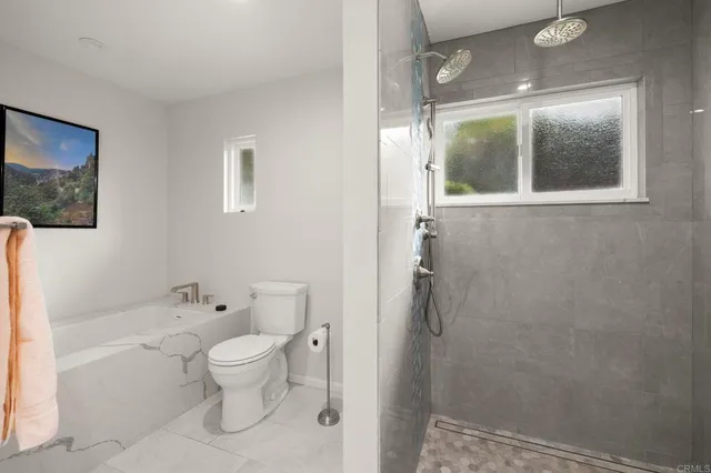 a bathroom with a toilet sink and shower