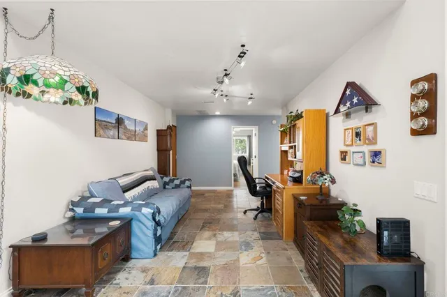 a living room with lots of furniture and a chandelier